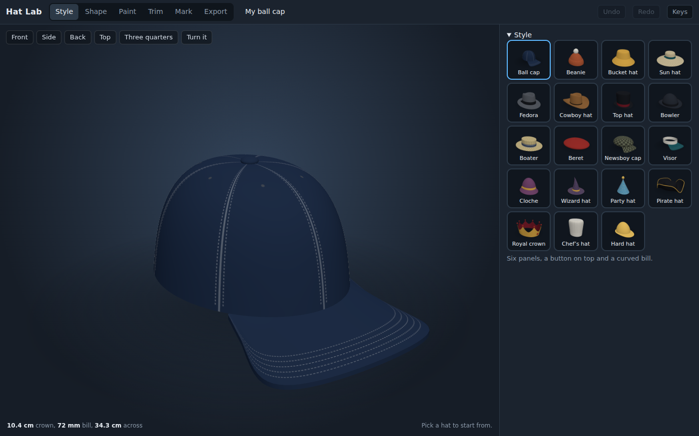Hat Lab's Style bench with the starter ball cap in 3D: a navy six-panel cap with a button on top, white stitching and a curved bill. Buttons above it turn the view to the front, side, back, top or three quarters. On the right, pictures of all nineteen styles to start from, from a beanie and a cowboy hat to a wizard hat, a pirate hat and a royal crown. The readout reads 10.4 cm crown, 72 mm bill, 34.3 cm across.