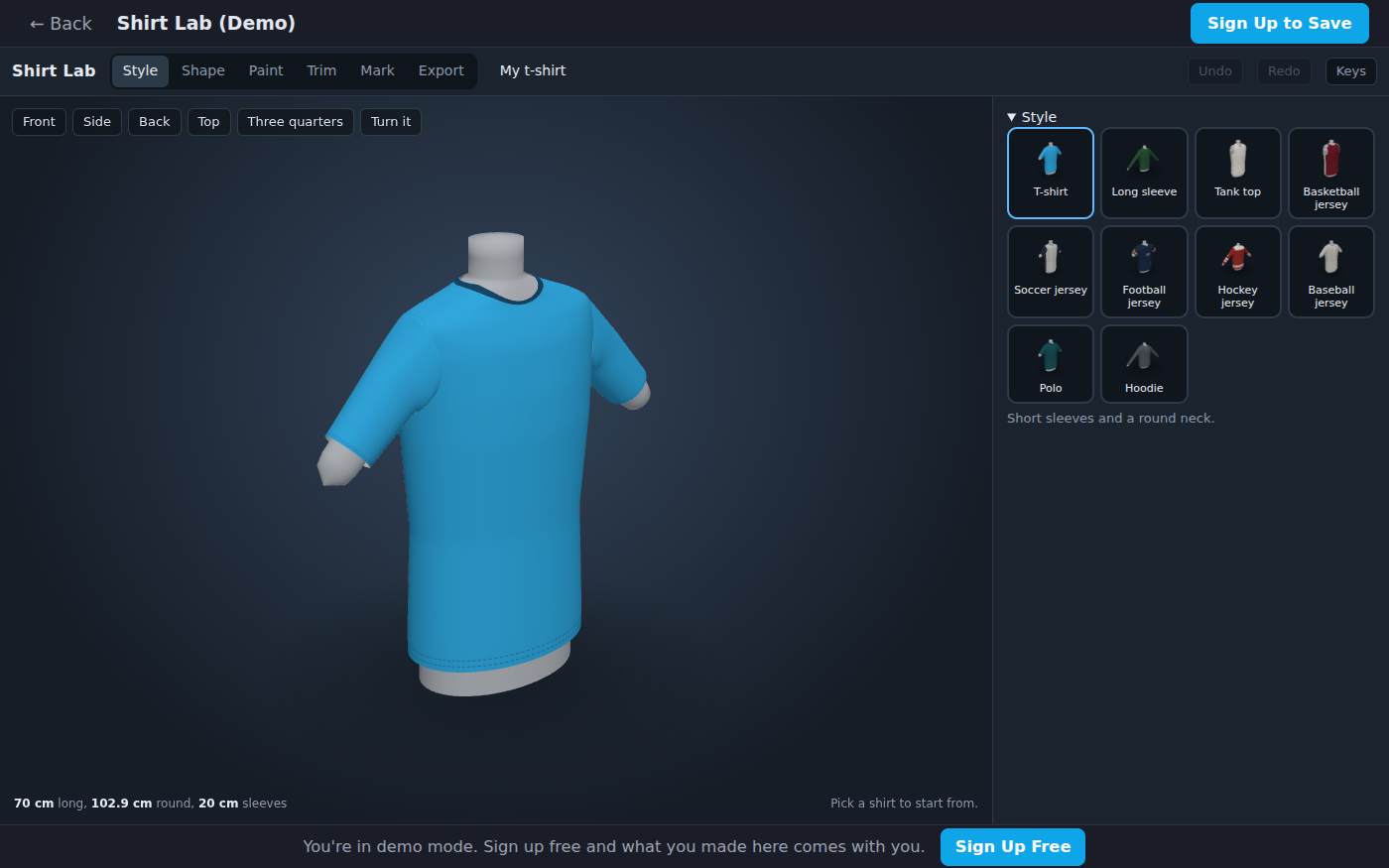 Shirt Lab's Style bench with the starter T-shirt in 3D, sky blue with a dark neckline, on a gray form with its arms out. On the right, pictures of the ten styles to start from: T-shirt, long sleeve, tank top, basketball, soccer, football, hockey and baseball jerseys, a polo and a hoodie. The readout reads 70 cm long, 102.9 cm round, 20 cm sleeves.